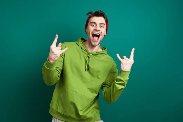 Excited Young Man Gesturing While Standing Green Background — Fotografia de Stock