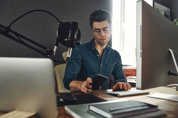 Handsome Young Man Using Smart Phone While Sitting Radio Station — Stockfoto