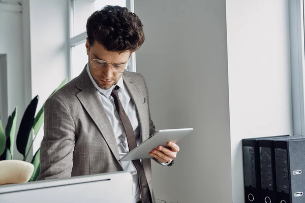 Concentrated Young Man Using Digital Tablet While Working Office — Stockfoto