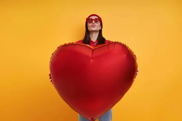 Happy Young Woman Holding Heart Shape Balloon Yellow Background — Fotografia de Stock