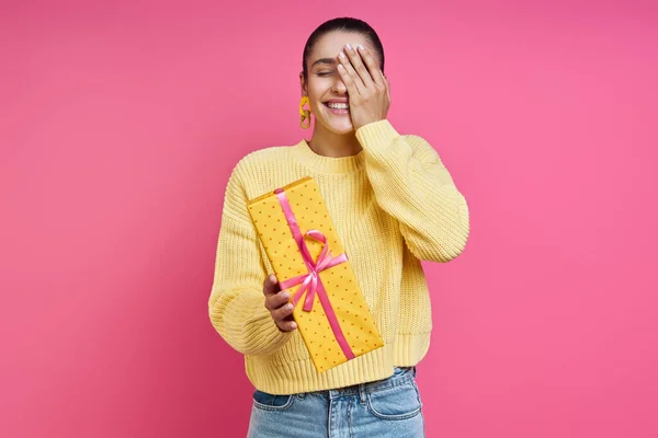 Beautiful Young Woman Holding Gift Box Smiling Colored Background — Stockfoto