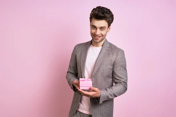 Happy Young Man Suit Holding Gift Box While Standing Pink — Foto Stock