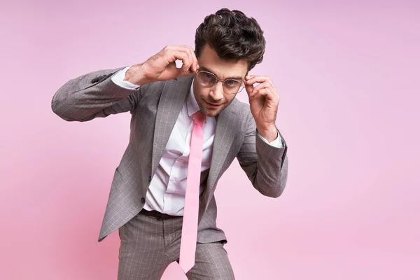 Confident Man Full Suit Adjusting His Eyeglasses While Standing Pink — Foto Stock