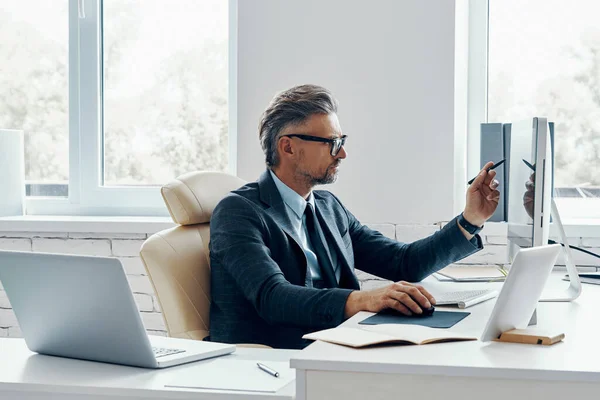 Confident Mature Businessman Pointing Computer Monitor While Sitting His Working — Photo