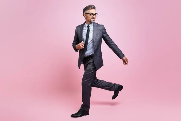 Confident Mature Man Full Suit Walking Pink Background —  Fotos de Stock