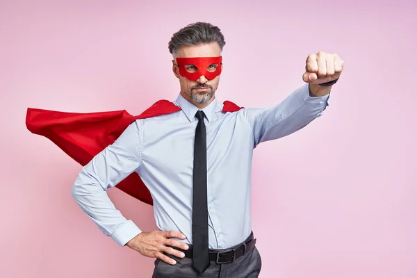 Confident Mature Man Wearing Superhero Cape Keeping Arm Outstretched Pink — Photo