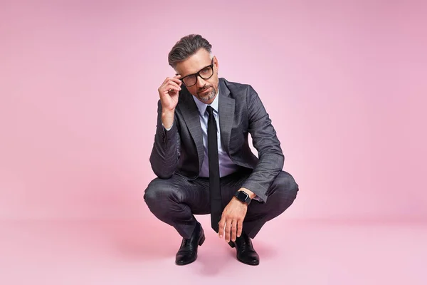 Handsome Mature Man Full Suit Adjusting His Eyeglasses While Sitting — Foto Stock