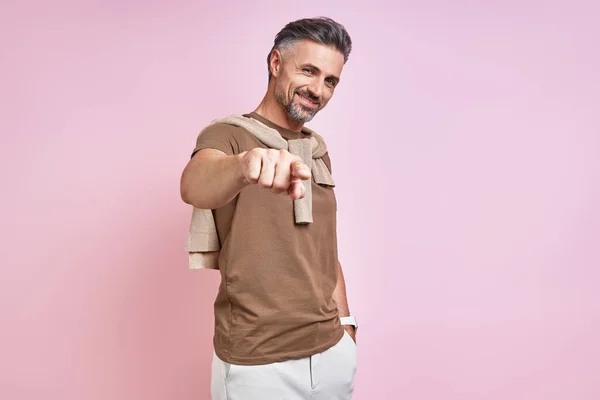 Cheerful Mature Man Pointing Camera While Standing Pink Background — Foto Stock