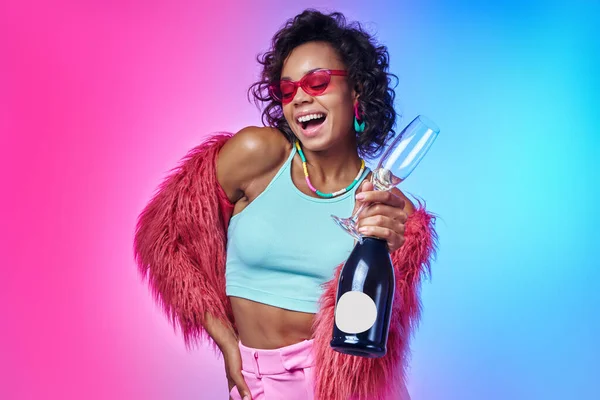 Happy African Woman Trendy Clothes Holding Bottle Sparkling Wine Colorful — Stock Photo, Image