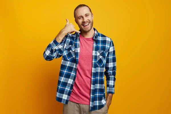 Happy Young Man Gesturing Mobile Phone While Standing Yellow Background — Stock Photo, Image