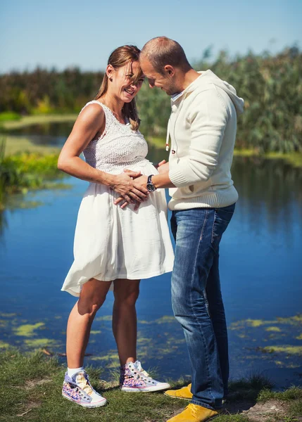 Husband touching wife's belly — Stock Photo, Image