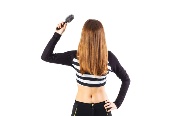 Woman holding brush close to her hair — Stock Photo, Image