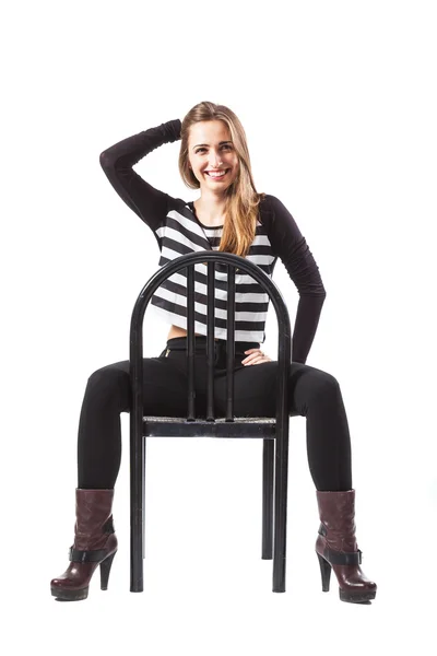 Relaxed woman sitting on a chair is smiling — Stock Photo, Image