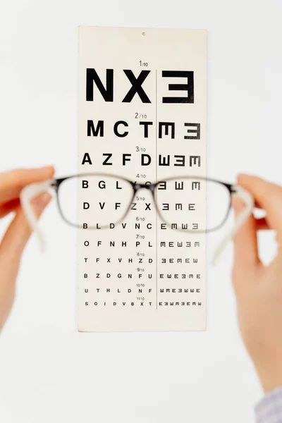 Blurry Pose Hands Holding Eyeglasses Front Eye Chart Isolated White — Stock Photo, Image