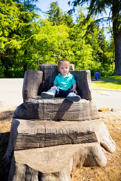 Boy Sitting on Stump Chair — Stock Photo, Image