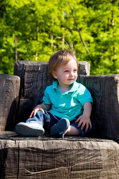 Boy Sitting on Stump Chair — Stock Photo, Image