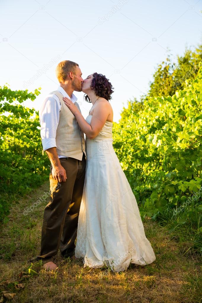 Wedding Couple Kissing in Vineyard