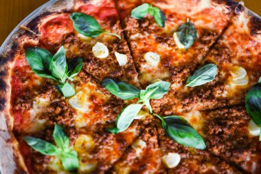 tasty bolognese pizza with fresh basil