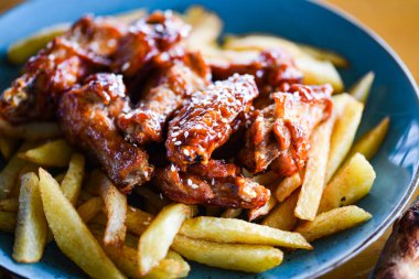 crispy barbecue chicken wings with fries