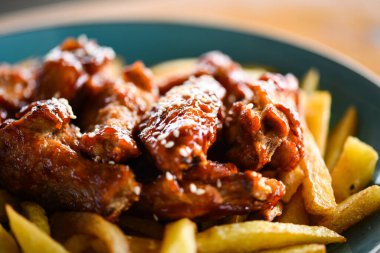 crispy barbecue chicken wings with fries