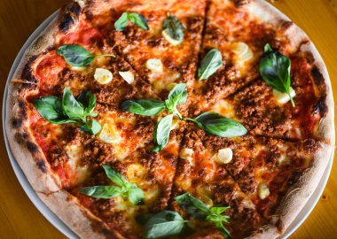 tasty bolognese pizza with fresh basil