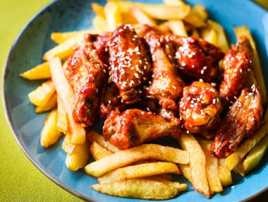 crispy barbecue chicken wings with fries