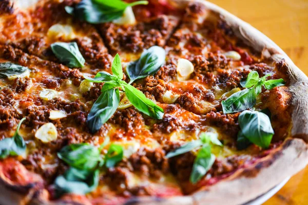 tasty bolognese pizza with fresh basil