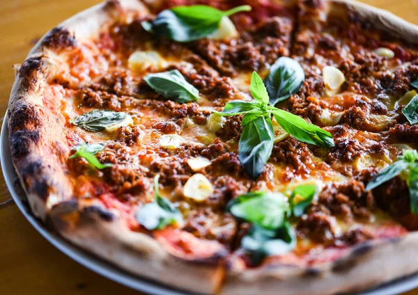 tasty bolognese pizza with fresh basil