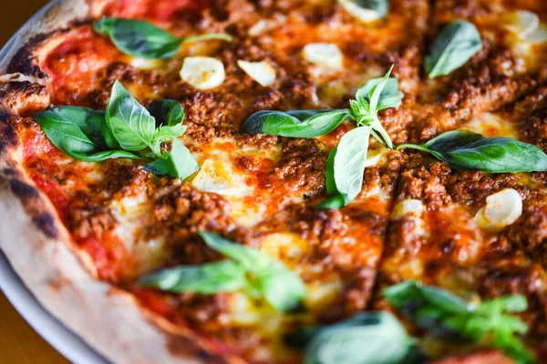 tasty bolognese pizza with fresh basil