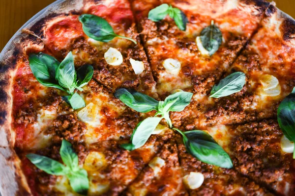 tasty bolognese pizza with fresh basil