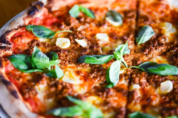 tasty bolognese pizza with fresh basil