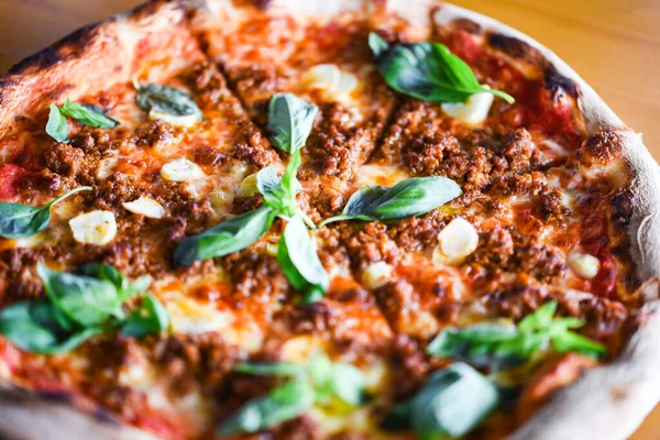 tasty bolognese pizza with fresh basil