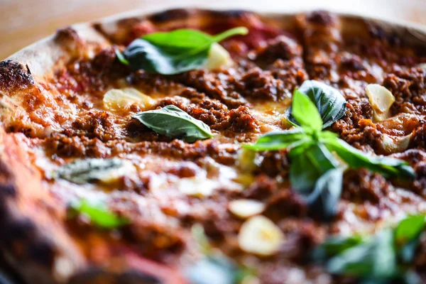 tasty bolognese pizza with fresh basil
