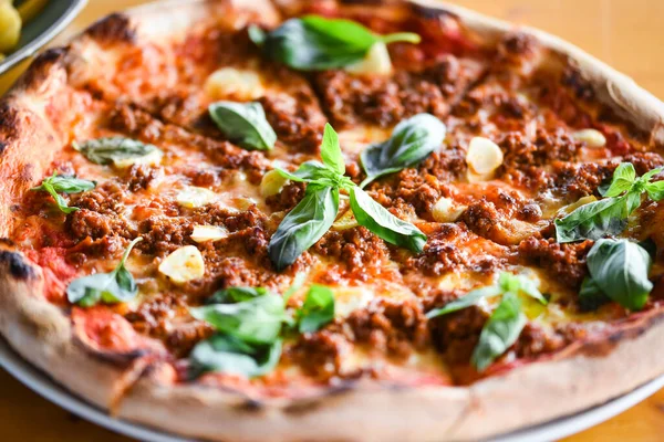 tasty bolognese pizza with fresh basil