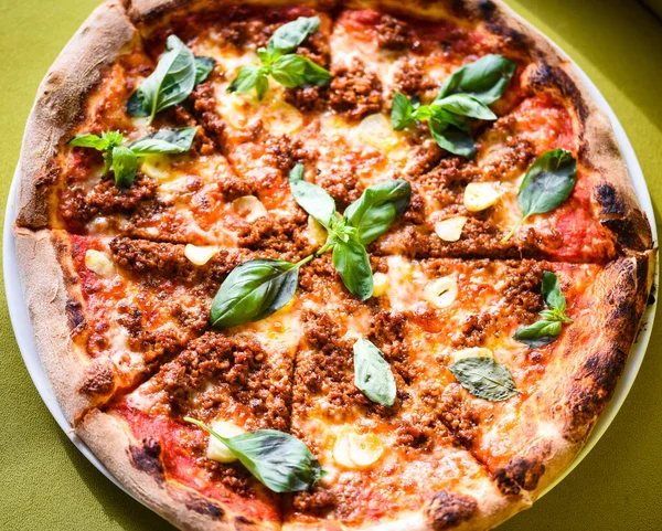 tasty bolognese pizza with fresh basil