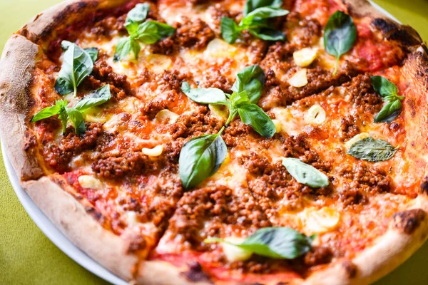 tasty bolognese pizza with fresh basil