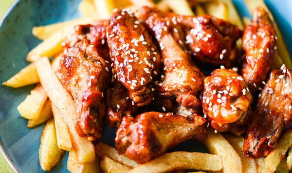 crispy barbecue chicken wings with fries