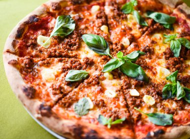 tasty bolognese pizza with fresh basil