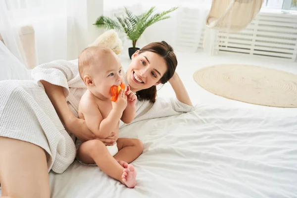 Happy Young Caucasian Mother Playing Her Baby Newborn Son Lying — Stock Photo, Image