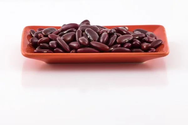 Red beans on a terracotta plate — Stock Photo, Image