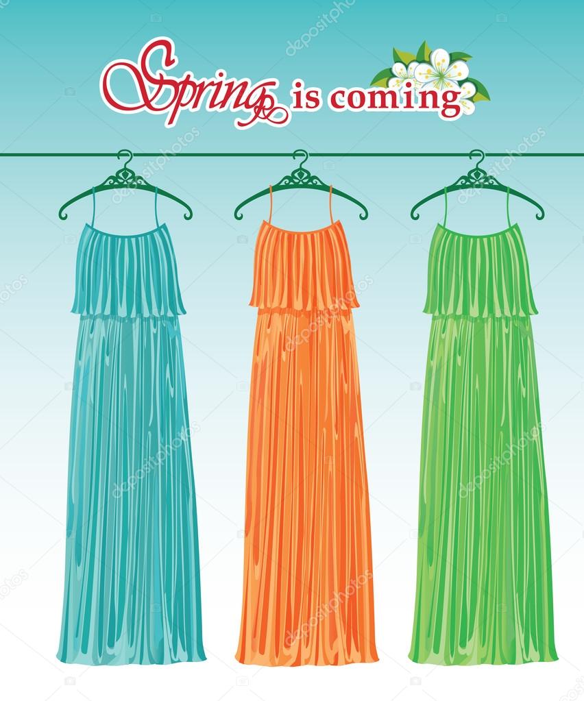 Three long spring party dresses on a hanger.Fashion boutique