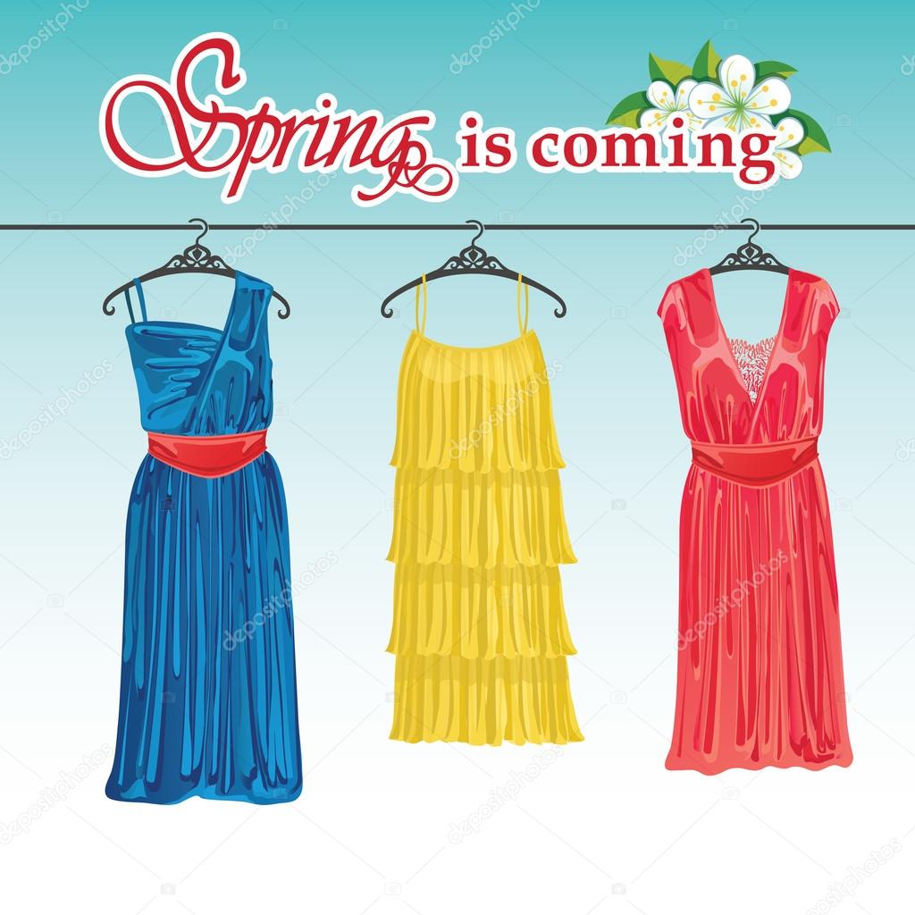 Three spring coctail dresses on a hanger.Spring fashion