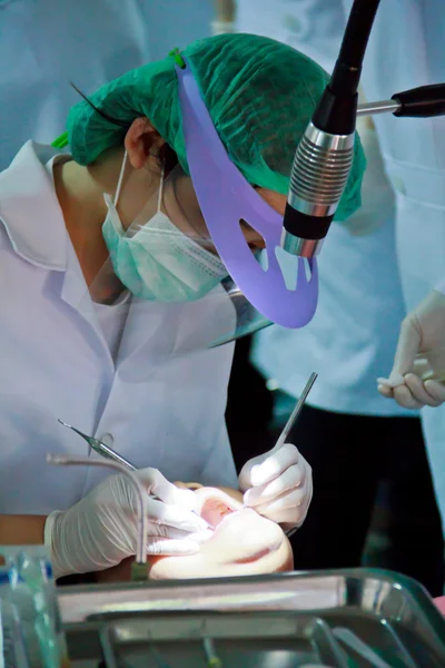 彼女の歯をチェックしてそれらを掘削上の歯科医のメスの患者の写真 — ストック写真
