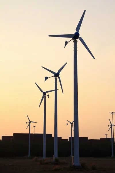 Wind turbine power generator at sunset — Stock Photo, Image