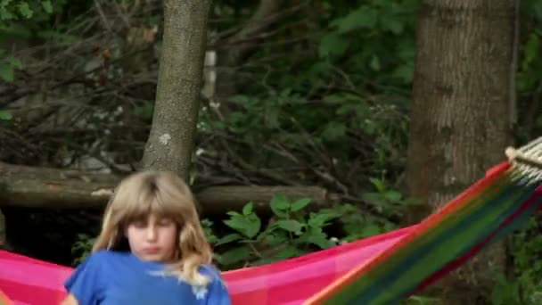 Boy swinging on a hammock, boy full of energy — Stock Video