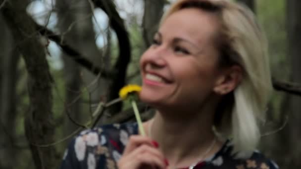 Beautiful girl in the woods,beautiful young girl with dandelion in the forest — Stock Video