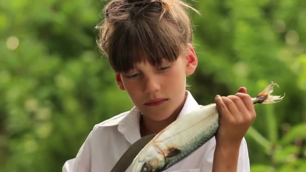 Niño sosteniendo un pez marino.Niño preparando pescado.Pequeño cocinero . — Vídeo de stock