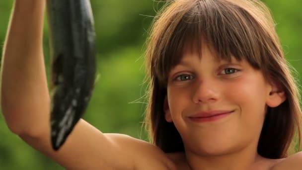 Boy holding a marine fish.Child preparing fish.Little cook. — Stock Video