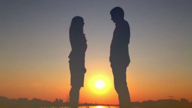 Aşk göl günbatımı, romantik tarihte öpüşme genç çift yavaşça öp, birbirine bakarak