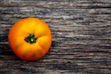 Fresh organic yellow tomatoes. Eco friendly non-gmo yellow tomatoes on the table. The concept of health, non-gmo products, clean ecological food. 